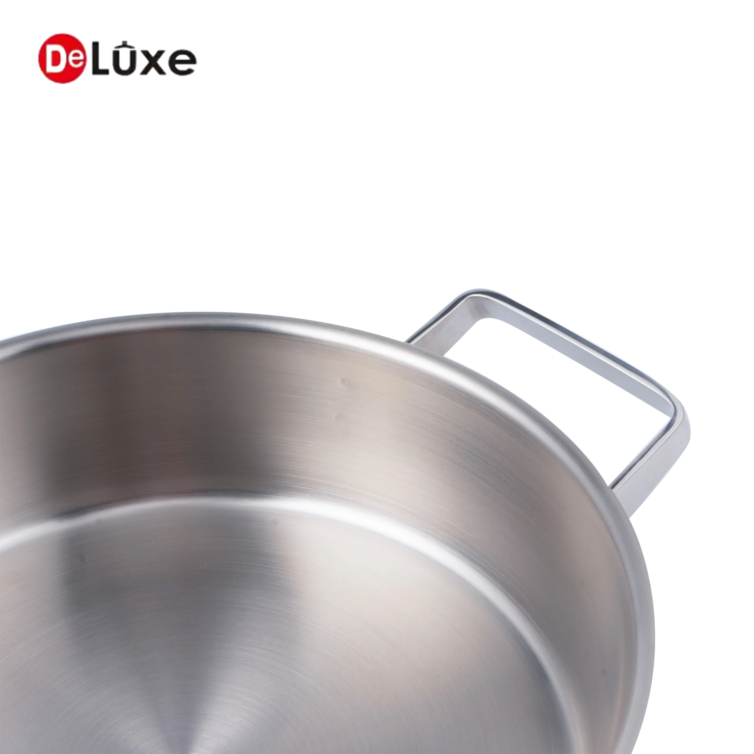 Close-up of pot rim and cast steel double handle base on slightly tilted stainless casserole