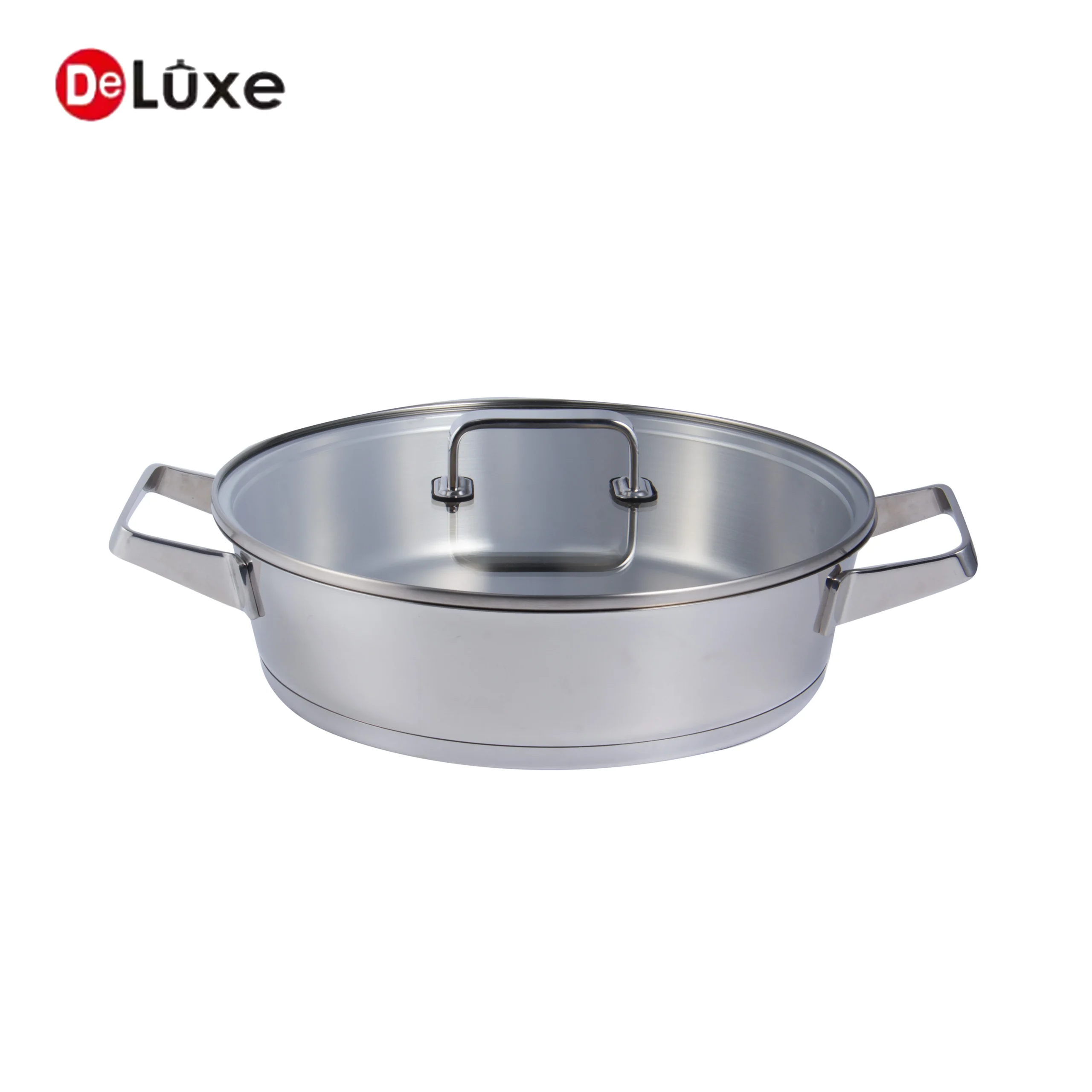 Open slightly tilted shallow casserole with double cast steel handles and glass lid resting inside